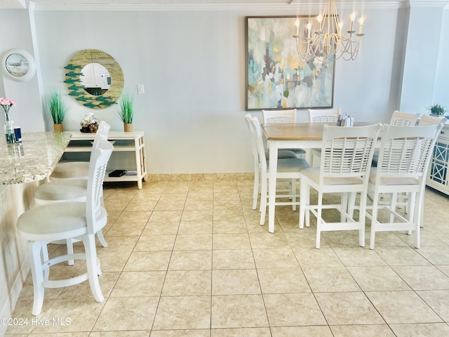 dining area with a chandelier, light tile patterned floors, and crown molding