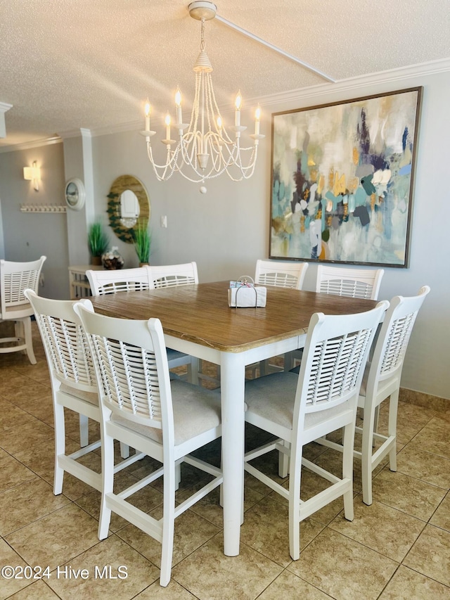 dining room with tile patterned flooring, a textured ceiling, crown molding, and a notable chandelier