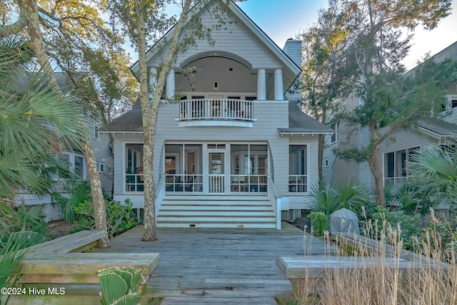 back of property with a balcony and a deck