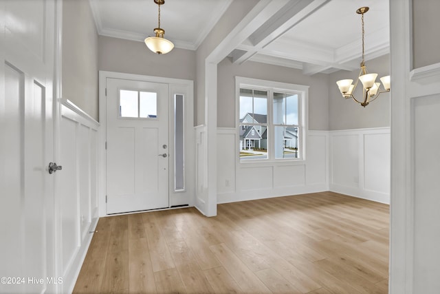 entrance foyer featuring beam ceiling, crown molding, a notable chandelier, and light wood-type flooring