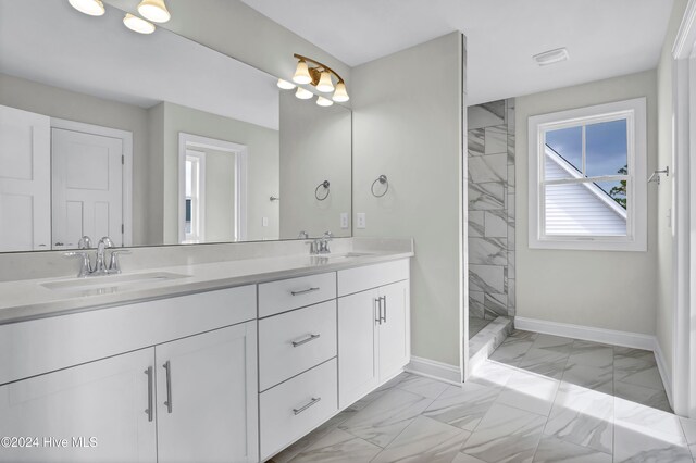 bathroom featuring vanity and a tile shower