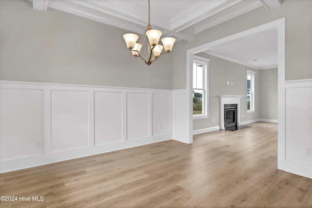 unfurnished dining area featuring a high end fireplace, crown molding, light hardwood / wood-style flooring, beam ceiling, and a chandelier