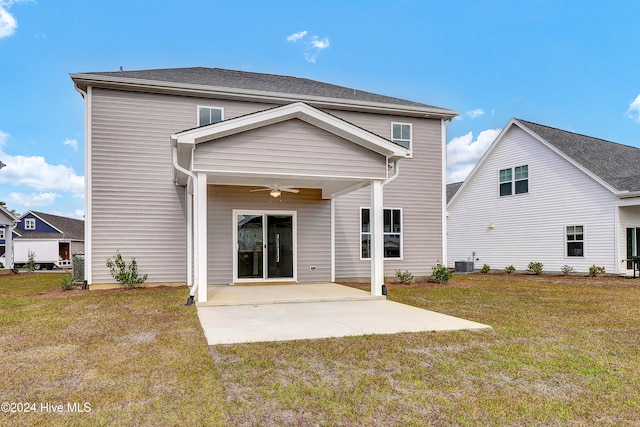 back of house featuring central air condition unit, ceiling fan, a yard, and a patio