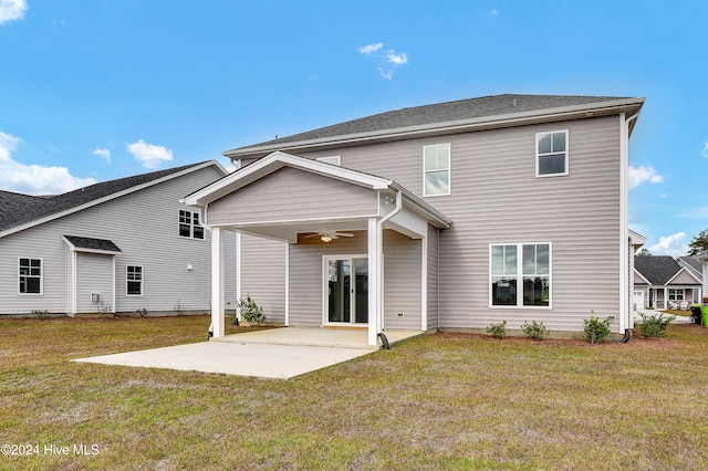 back of property featuring ceiling fan, a patio area, and a lawn