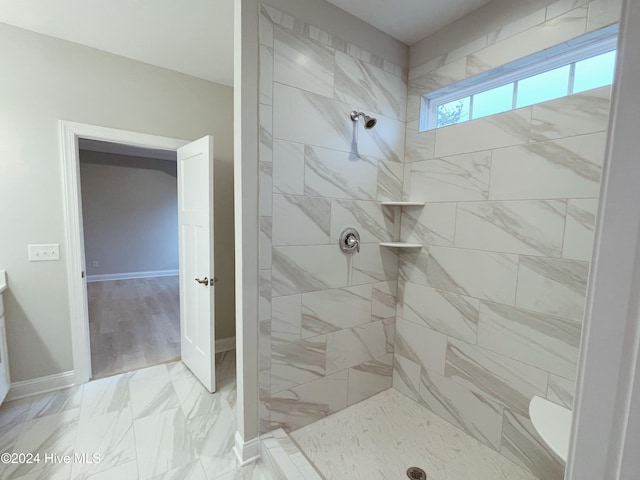 bathroom with vanity, toilet, wood-type flooring, and tiled shower