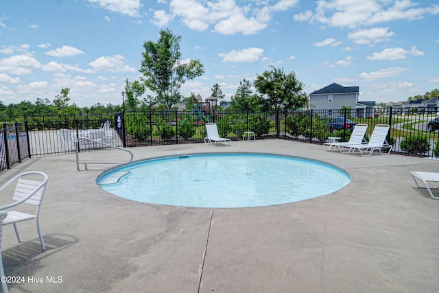 view of swimming pool with a patio