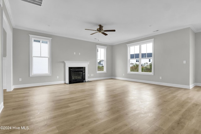 2765 Longleaf Pine Cir, Leland, NC 28451 - unfurnished living room featuring ceiling fan, a fireplace with flush hearth, crown molding, baseboards, and light wood finished floors