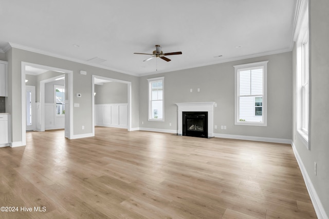 unfurnished living room with ceiling fan, light wood-type flooring, and crown molding