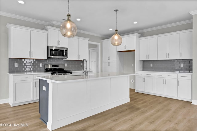 kitchen with decorative light fixtures, light hardwood / wood-style floors, white cabinetry, and stainless steel appliances