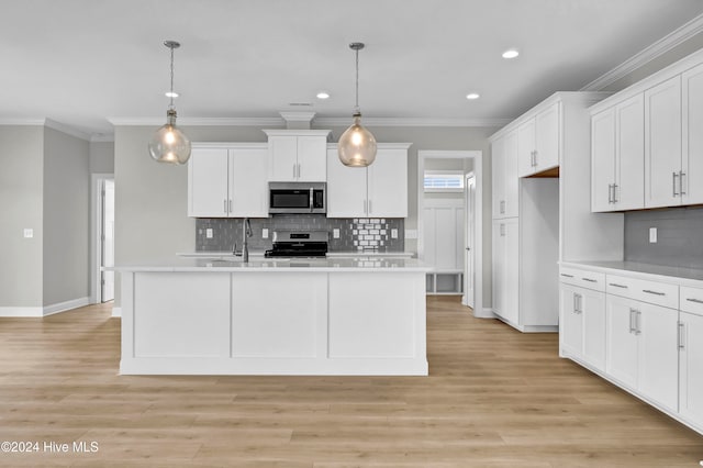 kitchen featuring pendant lighting, white cabinets, light wood-type flooring, and appliances with stainless steel finishes