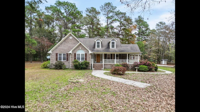 view of front of home with a porch and a front yard