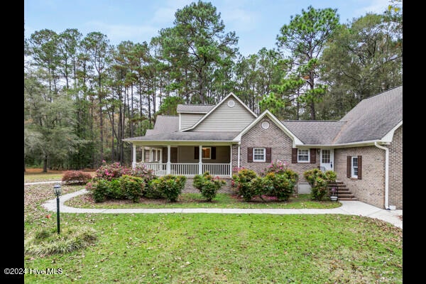 view of front of home featuring a front lawn and a porch