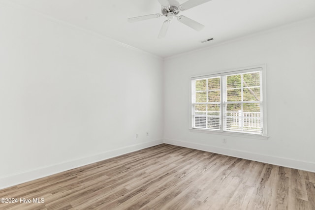 empty room with ceiling fan, light hardwood / wood-style floors, and ornamental molding