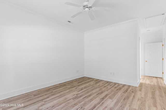 spare room featuring light wood-type flooring, ceiling fan, and ornamental molding