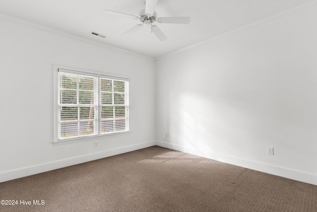 carpeted spare room featuring crown molding and ceiling fan