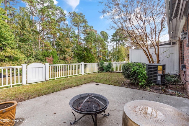 view of patio featuring central air condition unit and an outdoor fire pit