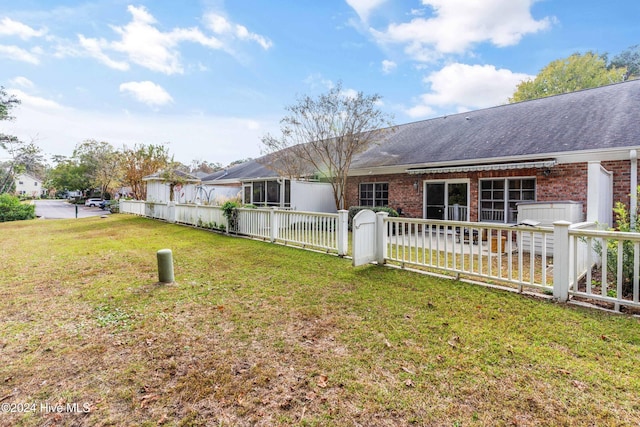 rear view of property with a yard