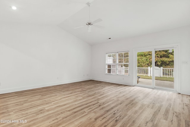 unfurnished room featuring ceiling fan, light hardwood / wood-style floors, and vaulted ceiling