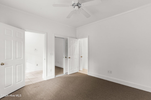 unfurnished bedroom featuring ceiling fan, light colored carpet, and ornamental molding