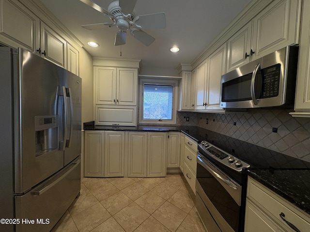 kitchen with ceiling fan, tasteful backsplash, dark stone counters, light tile patterned floors, and appliances with stainless steel finishes