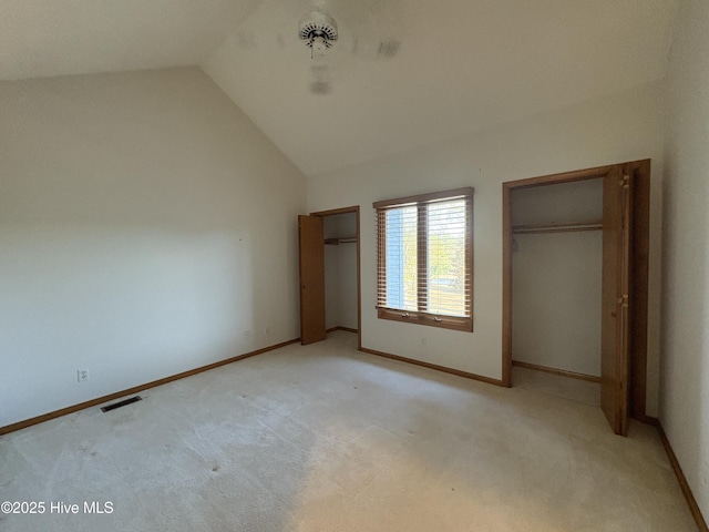 unfurnished bedroom with lofted ceiling and light carpet