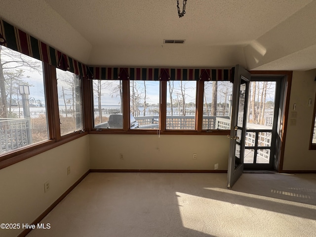 unfurnished sunroom featuring lofted ceiling