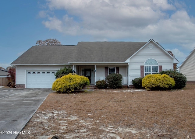 ranch-style house featuring covered porch and a garage