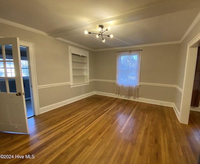 1121 Vance St N, Wilson, NC 27893 - unfurnished room featuring built in shelves, dark wood-type flooring, a chandelier, and crown molding