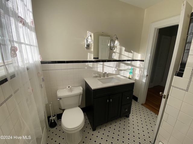 1121 Vance St N, Wilson, NC 27893 - bathroom featuring tile walls, vanity, and wainscoting
