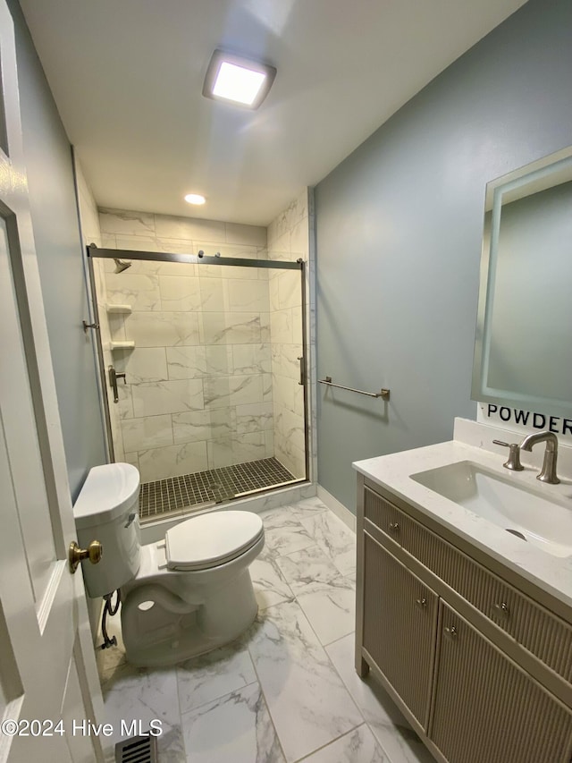 bathroom featuring an enclosed shower, vanity, and toilet