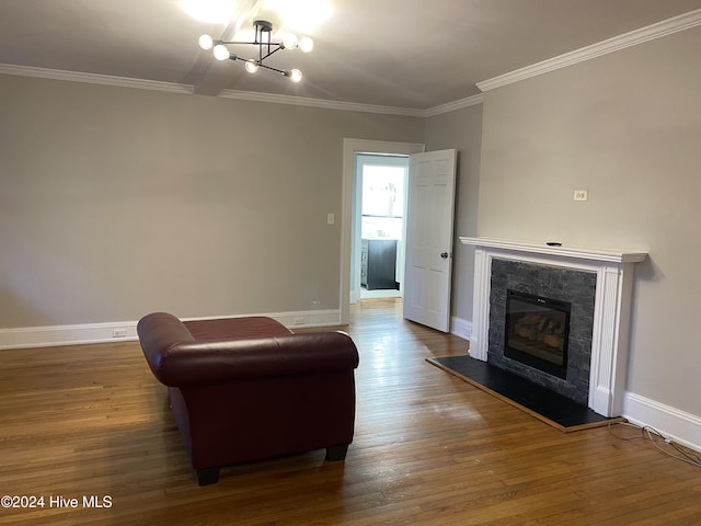 sitting room featuring crown molding, a chandelier, and dark hardwood / wood-style floors