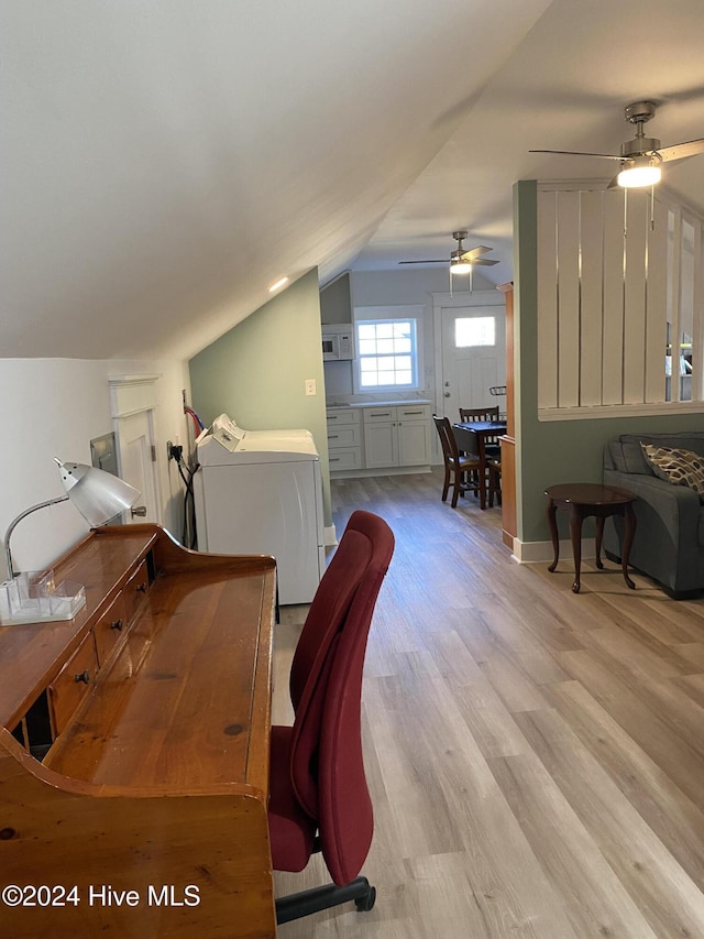 office space featuring ceiling fan, washer and dryer, light hardwood / wood-style floors, and lofted ceiling