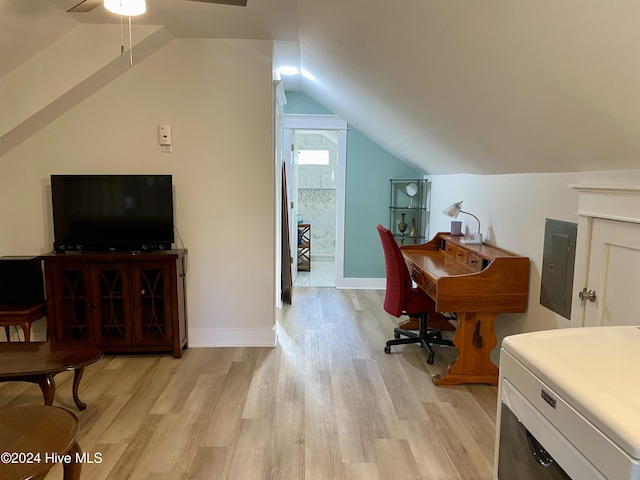 office featuring light wood-type flooring, vaulted ceiling, ceiling fan, washer / dryer, and electric panel