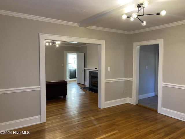 unfurnished room with dark hardwood / wood-style floors, an inviting chandelier, and ornamental molding