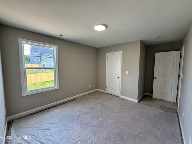 carpeted spare room with baseboards and visible vents