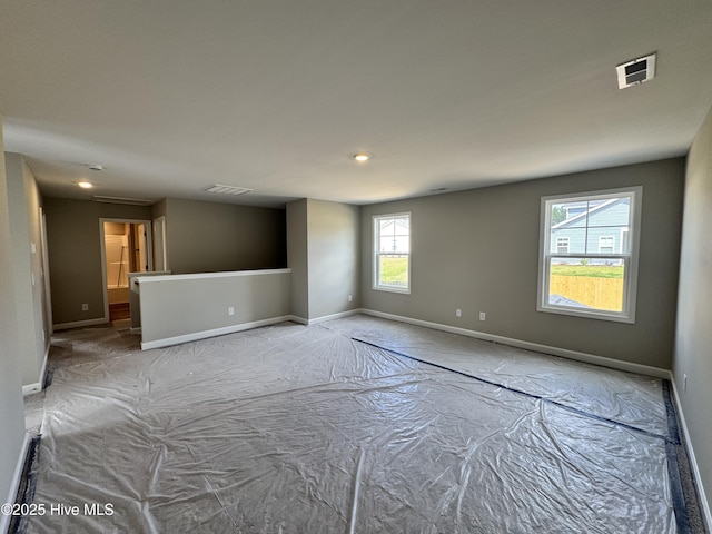 unfurnished room with baseboards, recessed lighting, and visible vents