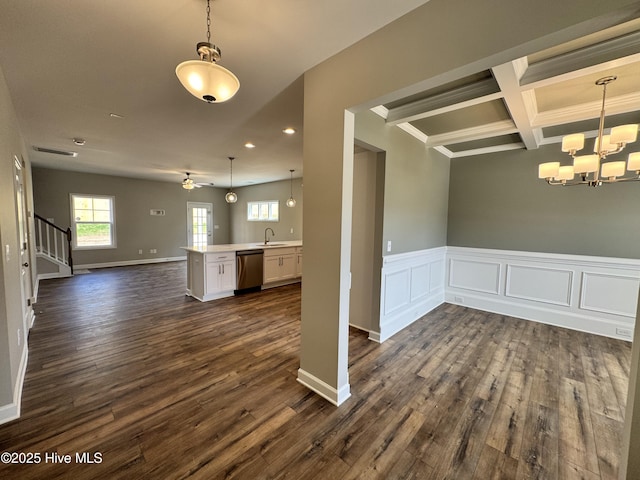 interior space featuring dark wood-style flooring, a sink, a chandelier, beamed ceiling, and stairway