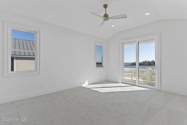 bonus room featuring a water view, light colored carpet, lofted ceiling, and ceiling fan