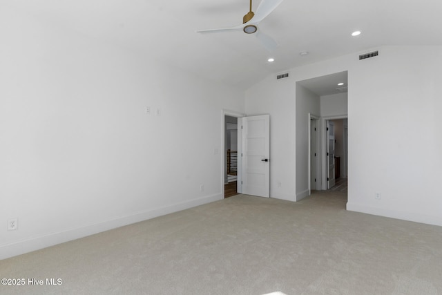 unfurnished bedroom with vaulted ceiling and light carpet