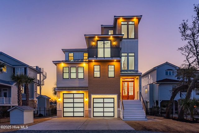 contemporary house featuring a balcony and a garage