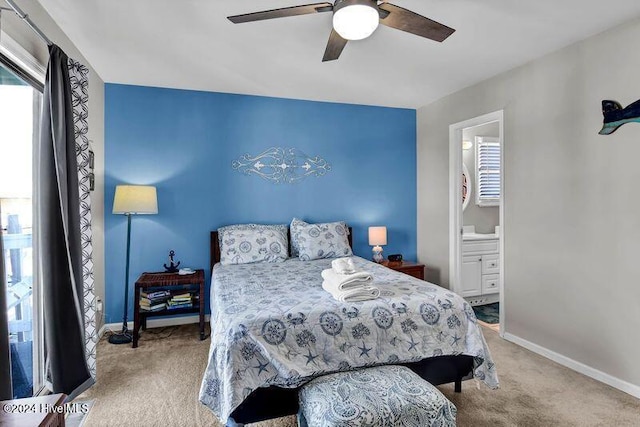 carpeted bedroom featuring ensuite bath and ceiling fan