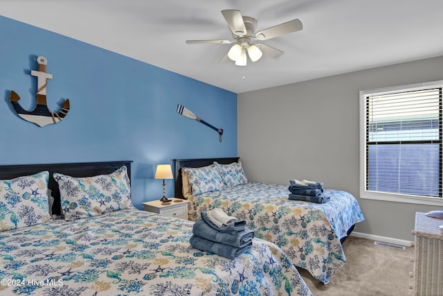 bedroom with ceiling fan and light carpet