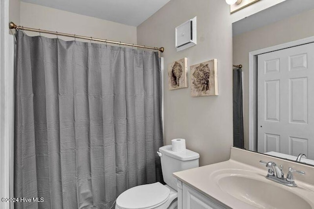 bathroom with a shower with curtain, vanity, and toilet