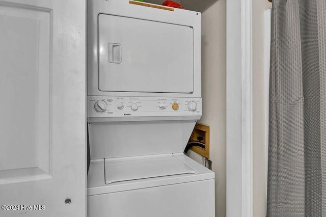 laundry room with stacked washing maching and dryer