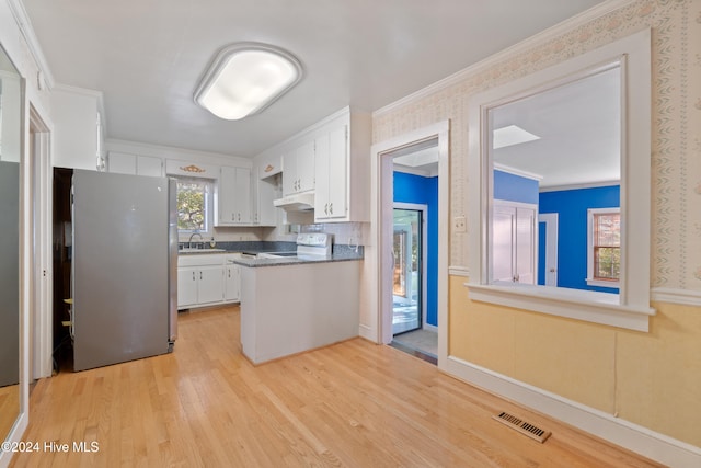 kitchen featuring white cabinets, white electric stove, ornamental molding, light hardwood / wood-style floors, and stainless steel refrigerator