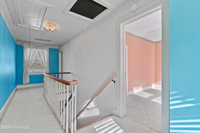 corridor featuring light colored carpet and ornamental molding