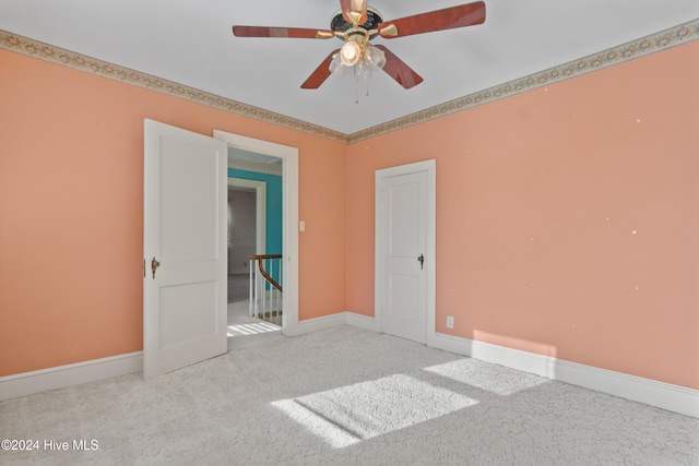 unfurnished room with carpet flooring and ceiling fan