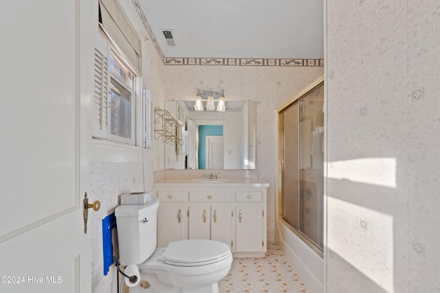 full bathroom featuring shower / bath combination with glass door, vanity, and toilet