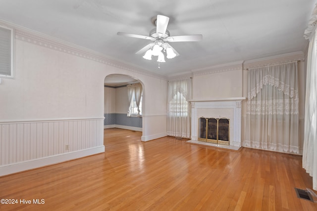 unfurnished living room with light wood-type flooring, ceiling fan, and crown molding