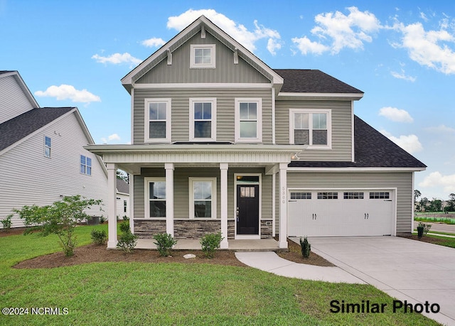 craftsman-style home featuring a front lawn, covered porch, and a garage